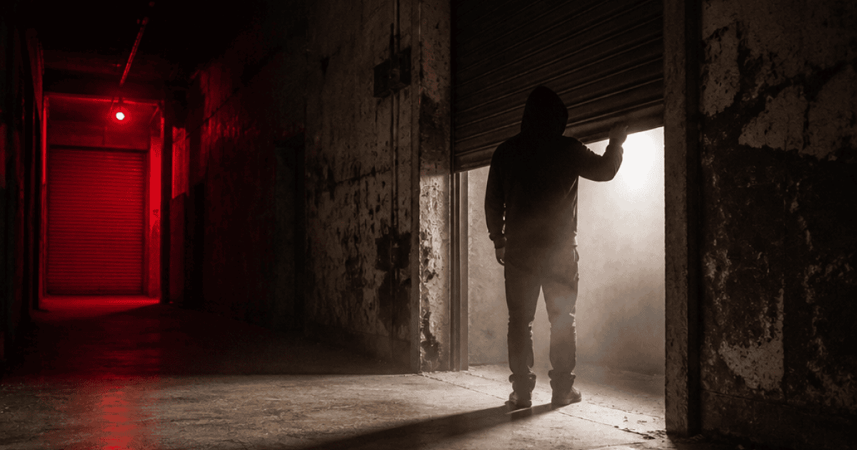 Dusty storage unit opening into red light, illustrating the Post Malone August 26th mixtape 10 year reissue